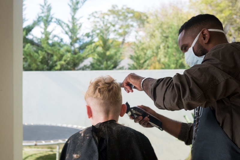 Mobile Barber doing a fade to a child