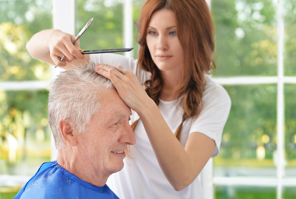 at-home hair stylist with senior customer